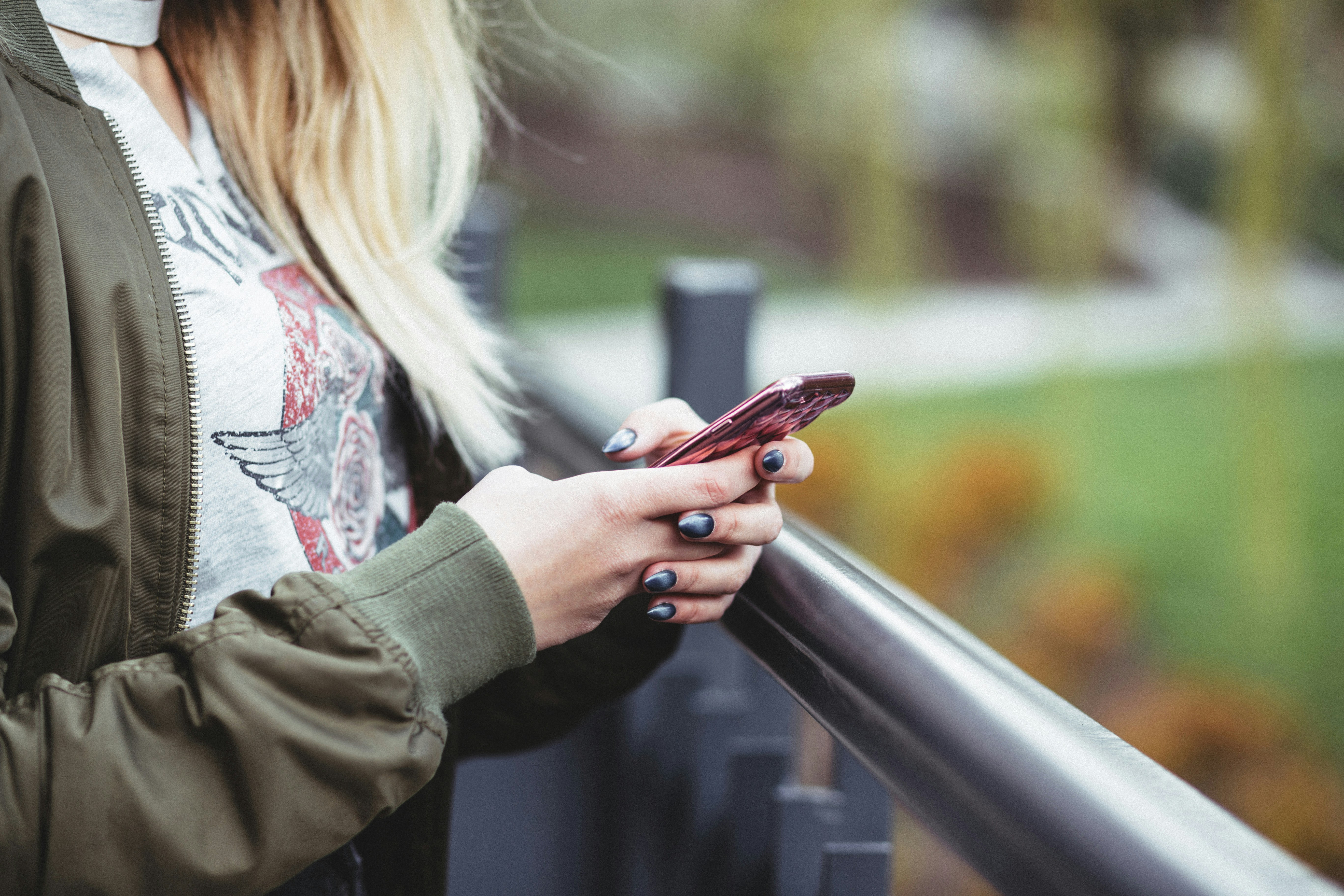 Woman holding her phone in nature